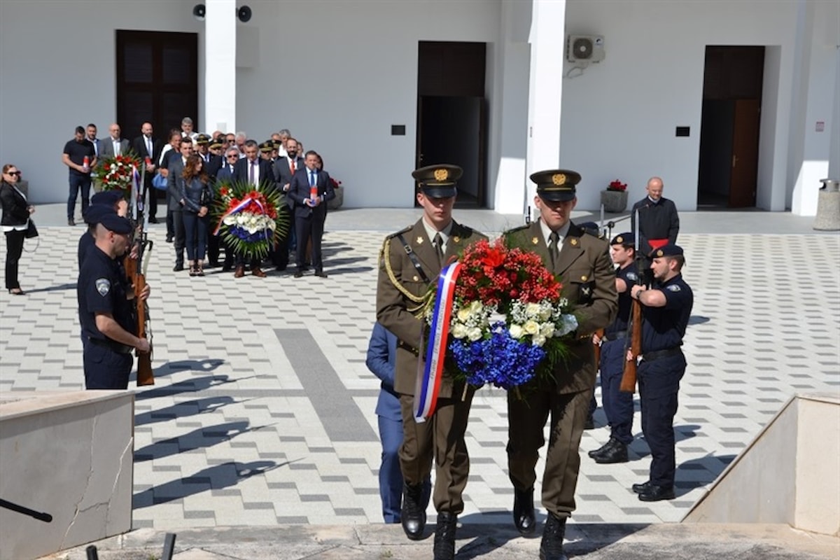 Položeni vijenci i zapaljene svijeće podno Središnjeg križa na gradskom groblju Kvanj